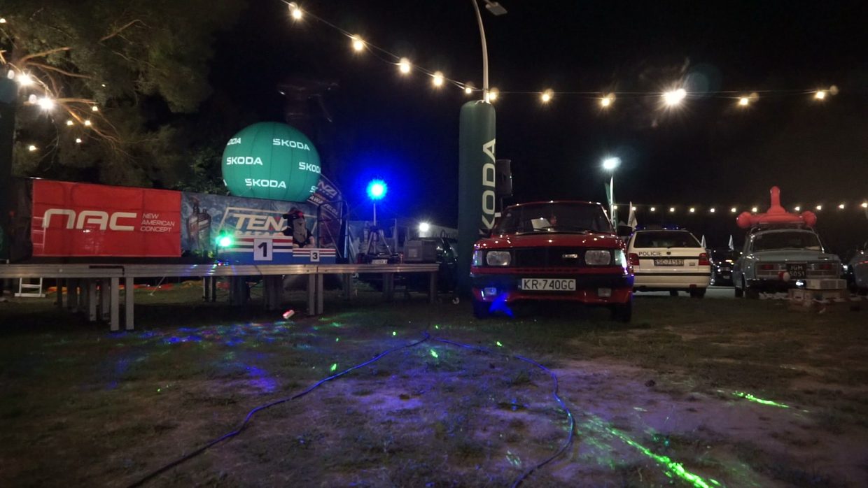 An outdoor event — stage, screens and light as one whole.