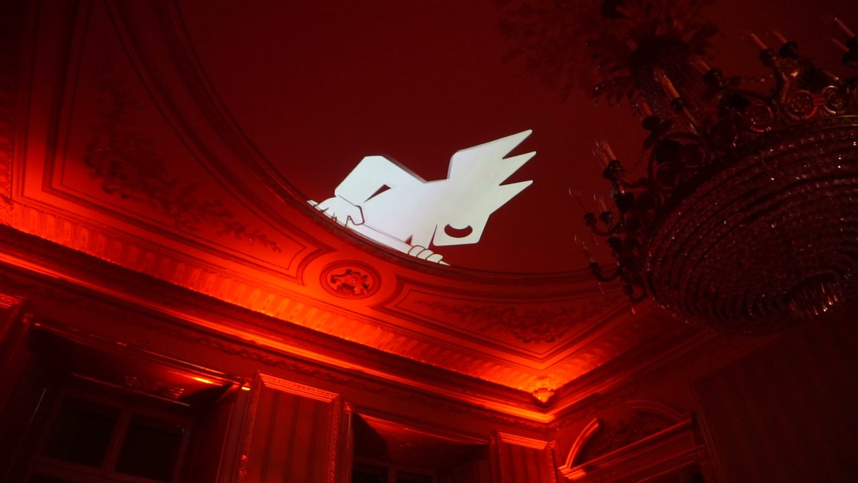 The client’s animated logo on a wall. Guests film it themselves and tag the venue, so the visuals keep working for reach long after the event.
